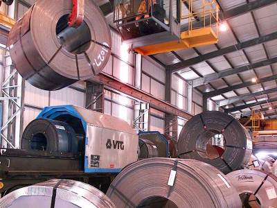 Crane loading steel coils to a train